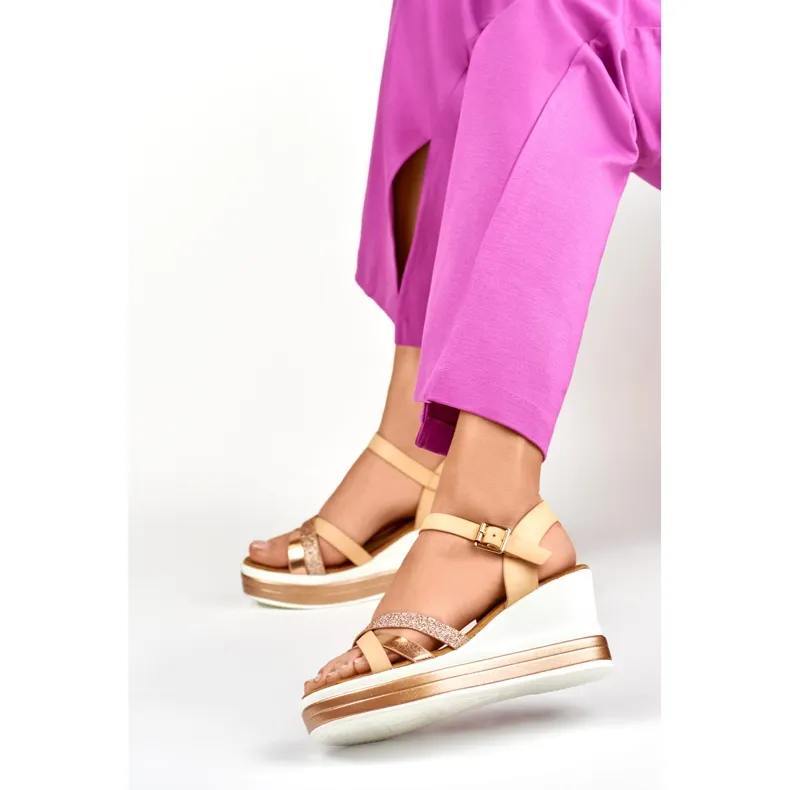 Beige wedge sandals with a shiny strap