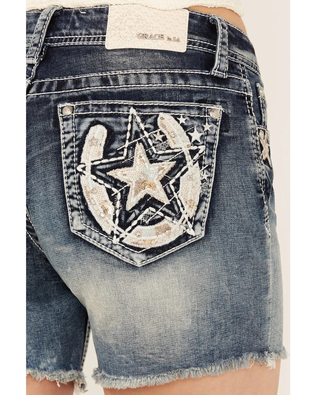 Grace In LA Light Wash Sequin Horseshoe Pocket Mid Rise Cutoff Stretch Denim Jeans