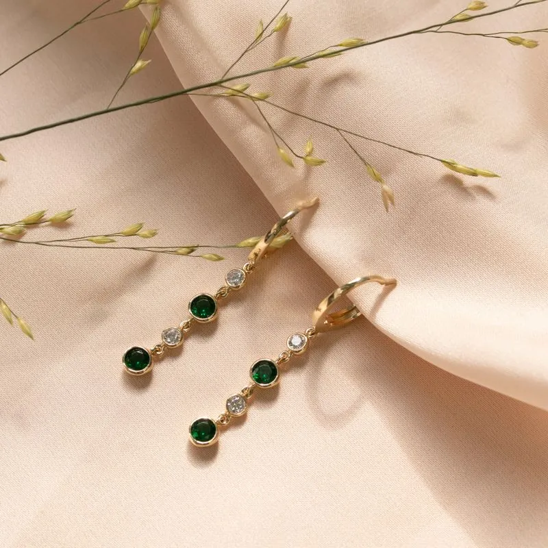 Yellow gold dangling earring with 2 green and white zircons